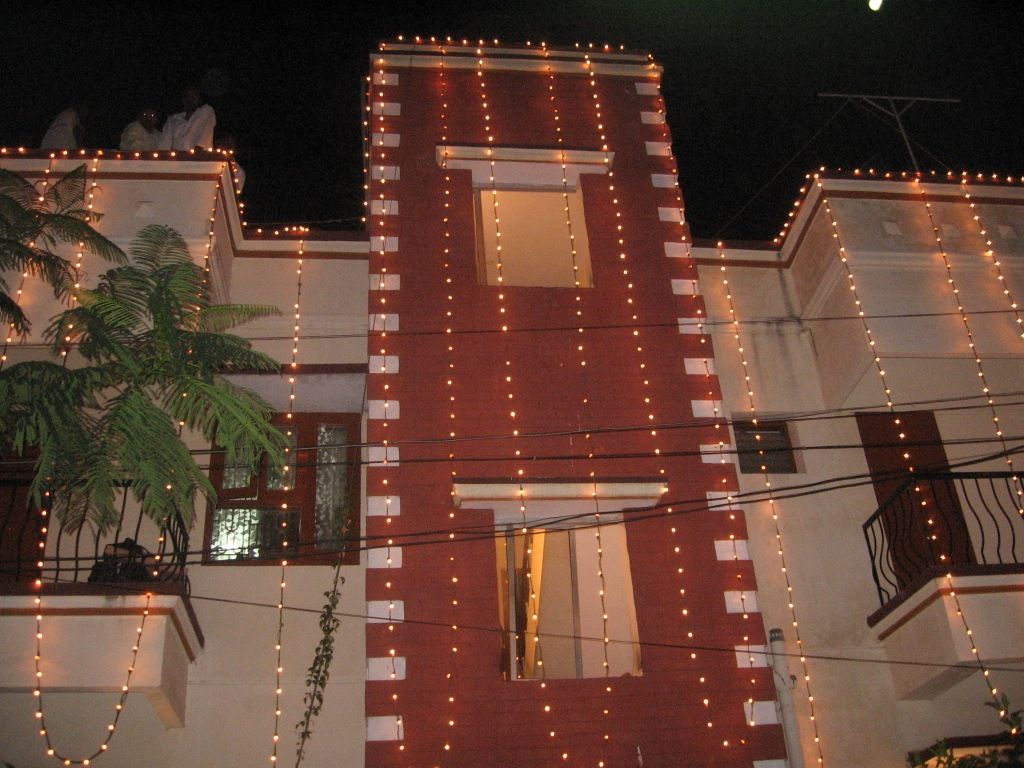 The hostel building lit up with festive lights at night