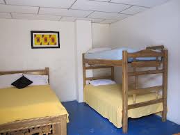 Three sharing room at Swarnaa Ladies Hostel with a single bed and a bunk bed